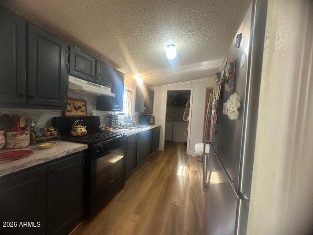 7258 South Lariat Road Hereford, AZ 85615 - Photo 7 of 37 a kitchen with stainless steel appliances granite countertop a refrigerator a sink a stove and cabinets