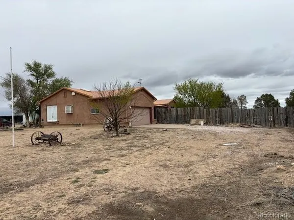 a backyard of a house with table and chairs
