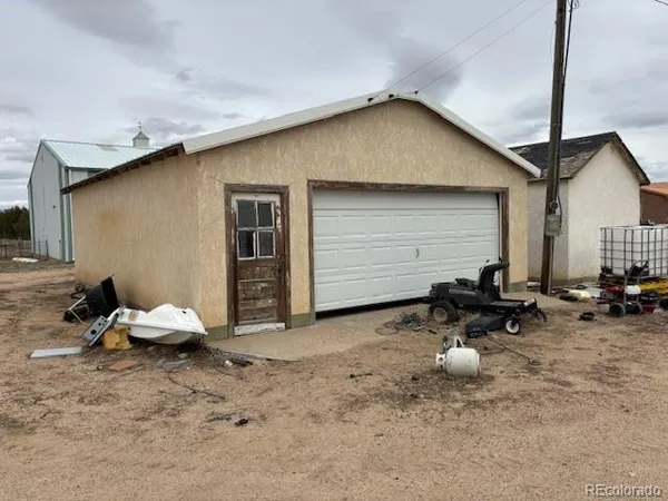 a backyard of a house with table and chairs