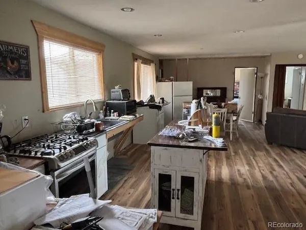 a living room with furniture window and wooden floor