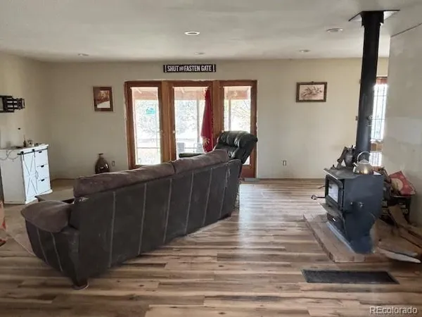 a view of a dining room with furniture wooden floor and a refrigerator