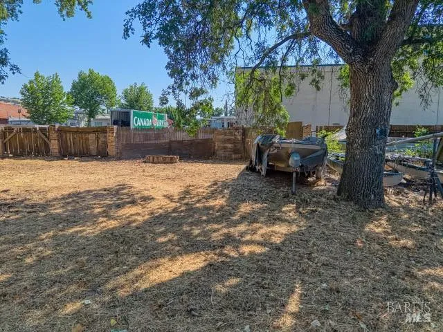 a backyard of a house with table and chairs