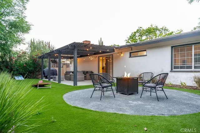 a backyard of a house with table and chairs