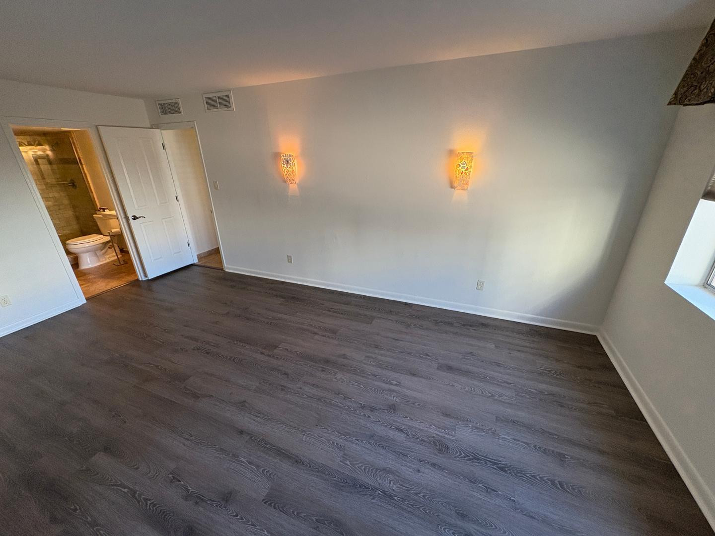 7850 East Camelback Road, Unit 109 Scottsdale, AZ 85251 - Photo 15 of 26 an empty room with wooden floor and windows