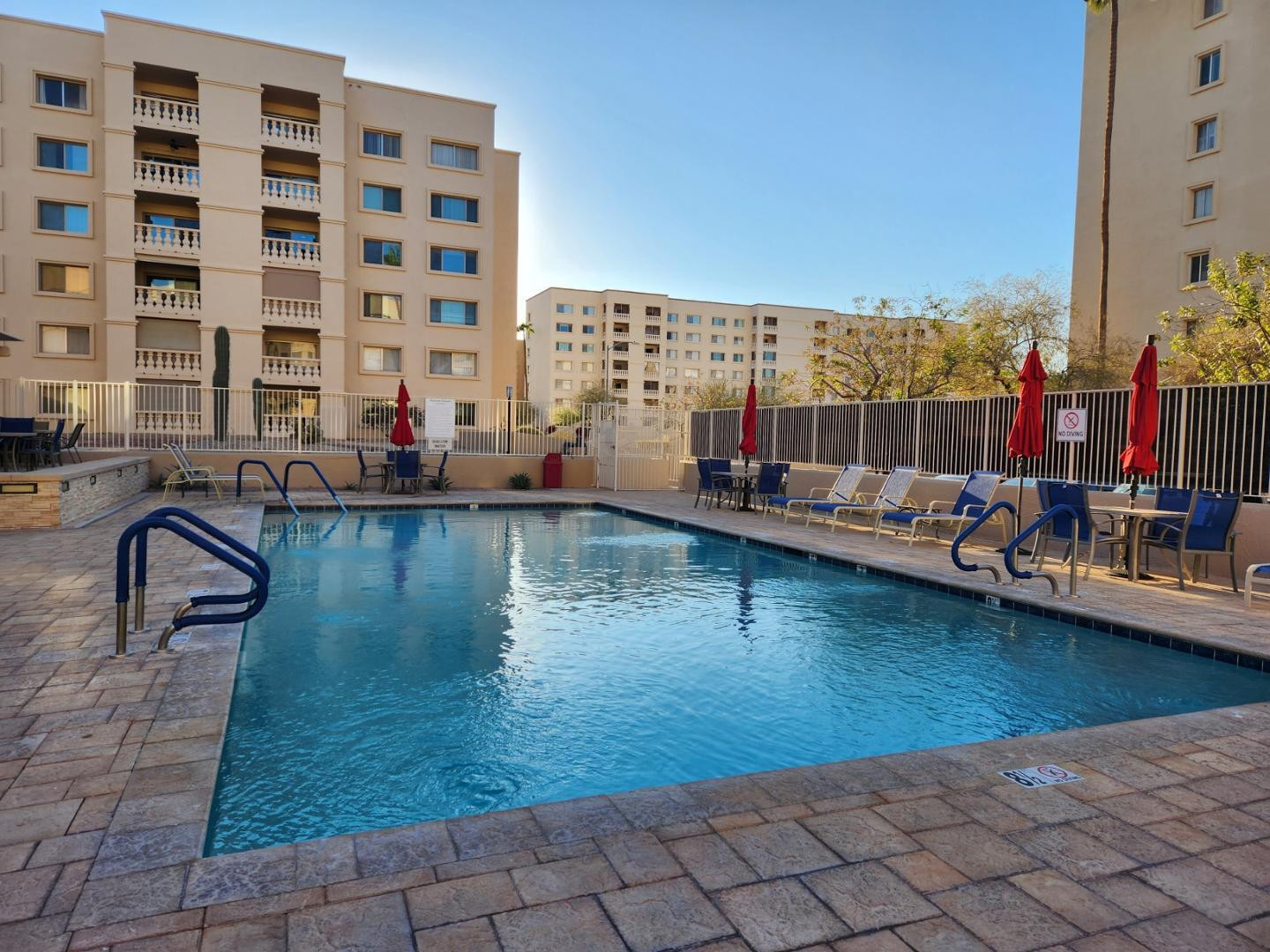 7850 East Camelback Road, Unit 109 Scottsdale, AZ 85251 - Photo 21 of 26 a view of a swimming pool with a lounge chairs