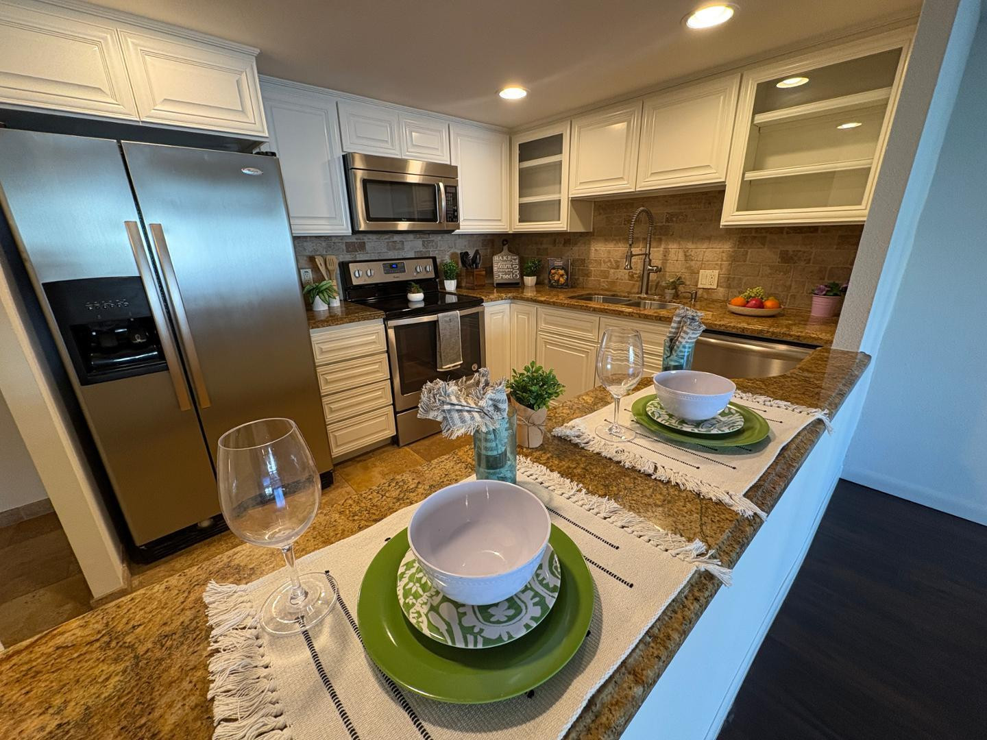 7850 East Camelback Road, Unit 109 Scottsdale, AZ 85251 - Photo 3 of 26 a kitchen with stainless steel appliances granite countertop a sink a stove and a refrigerator