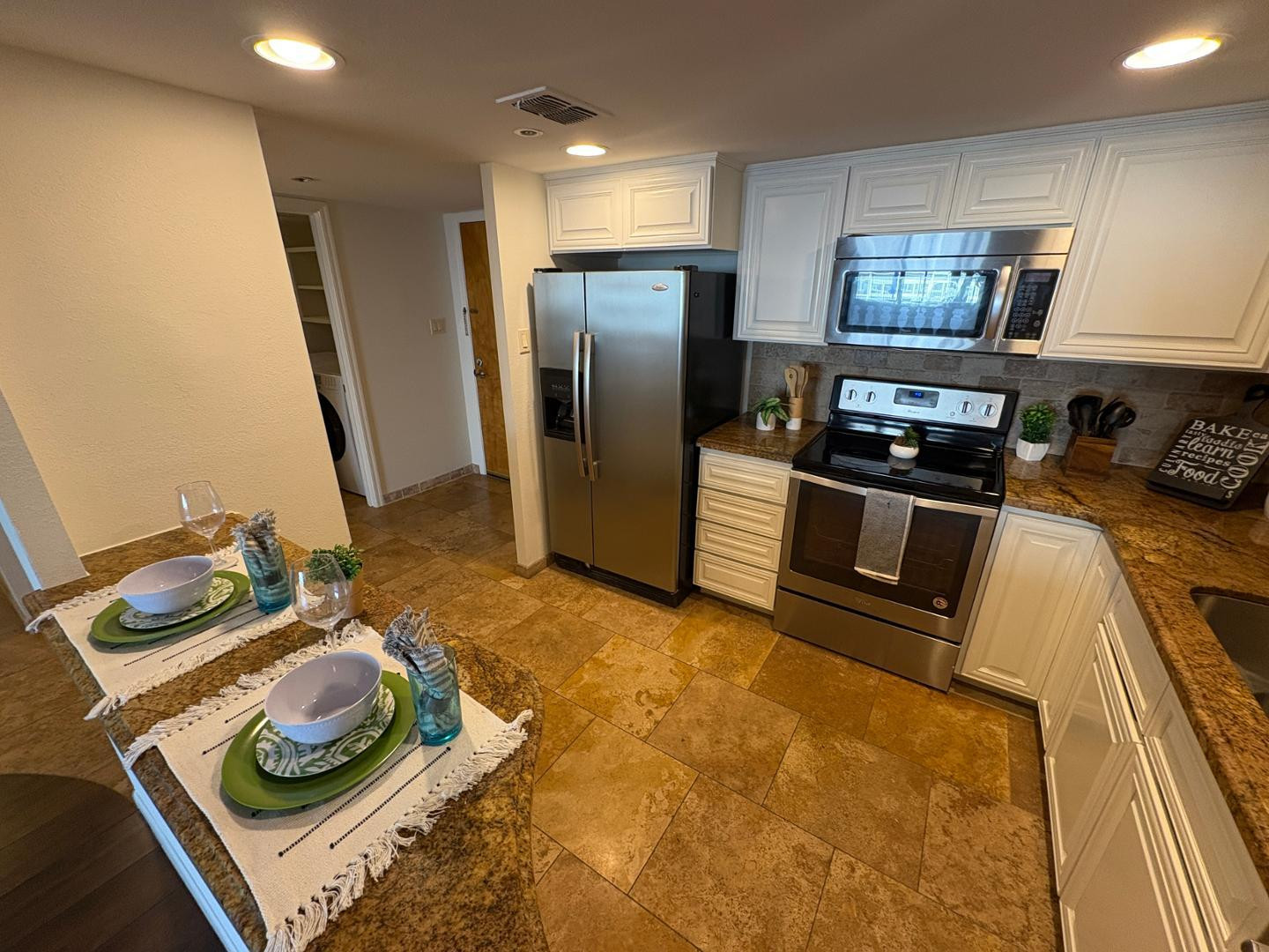 7850 East Camelback Road, Unit 109 Scottsdale, AZ 85251 - Photo 4 of 26 a kitchen with stainless steel appliances granite countertop a sink stove and refrigerator