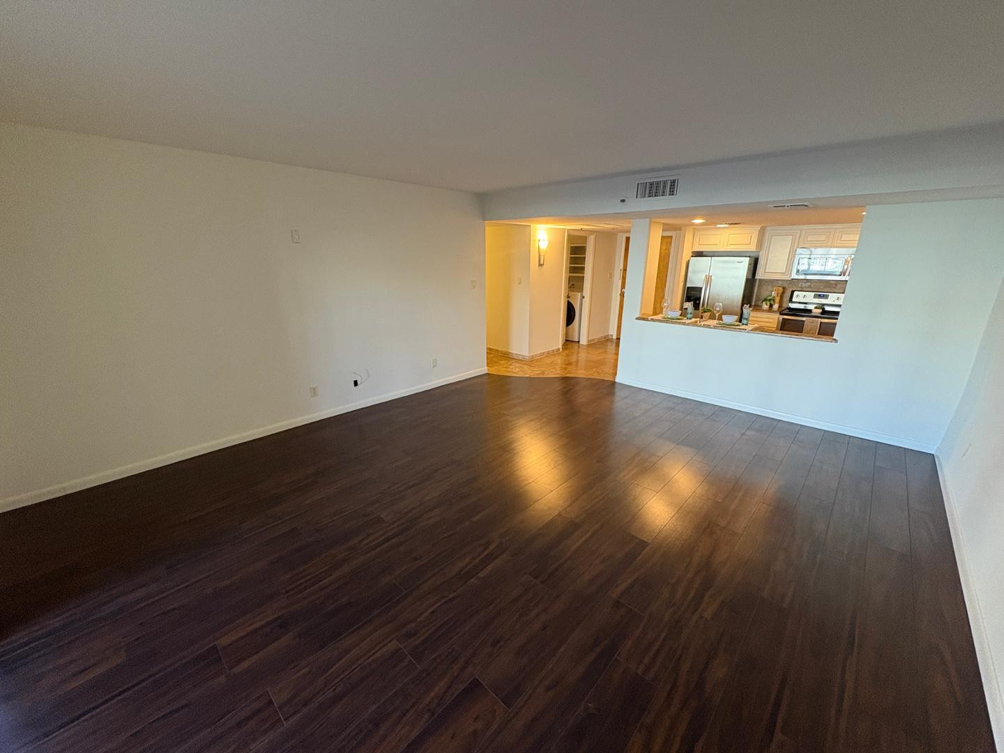 7850 East Camelback Road, Unit 109 Scottsdale, AZ 85251 - Photo 8 of 26 a view of an empty room with wooden floor and a window