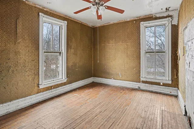 wooden floor in an empty room with a window