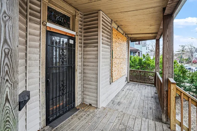 a view of balcony with wooden floor and fence