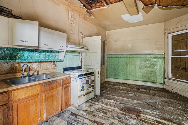 a kitchen with a sink stove and cabinets
