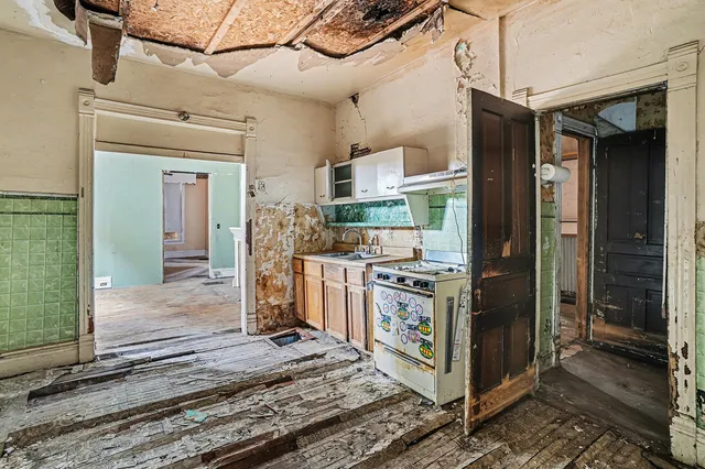 a kitchen with stainless steel appliances granite countertop a stove and a refrigerator