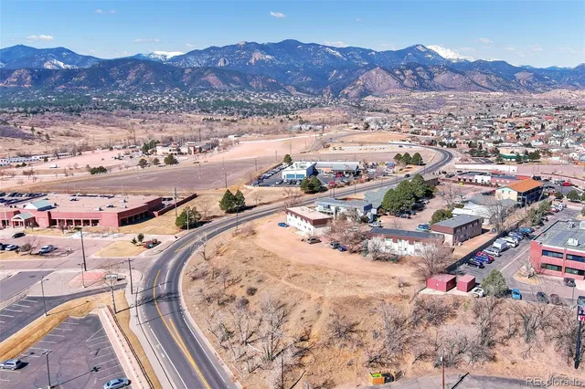 an aerial view of a house and mountain view