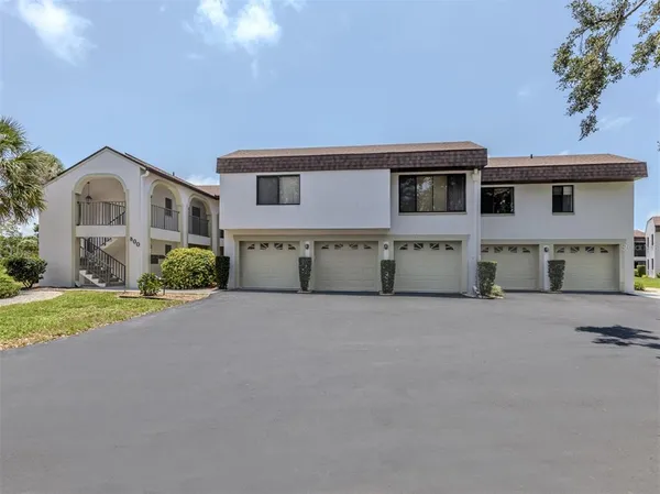 a view of a house with a yard and garage