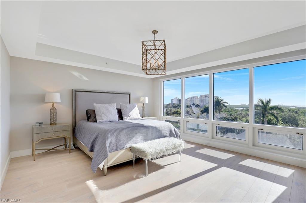 13915 Old Coast Road, Unit 502 Naples, FL 34110 - Photo 12 of 31 a bedroom with a large bed and a window