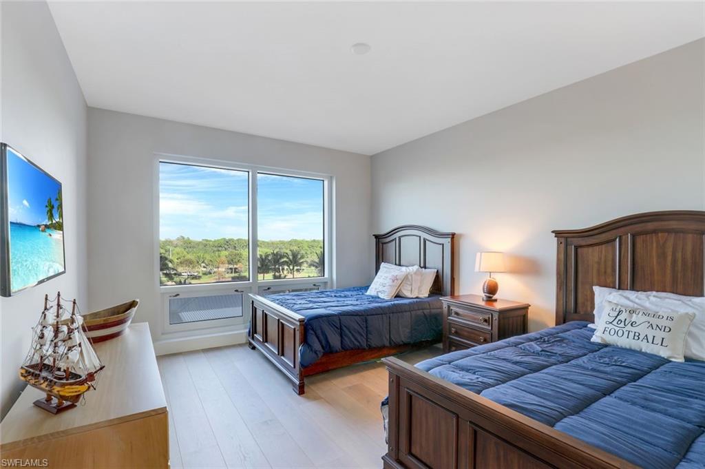 13915 Old Coast Road, Unit 502 Naples, FL 34110 - Photo 15 of 31 a bedroom with two beds and large window