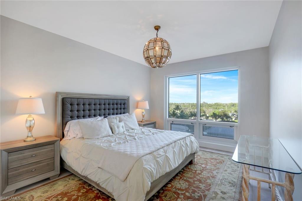 13915 Old Coast Road, Unit 502 Naples, FL 34110 - Photo 17 of 31 a bedroom with bed and window