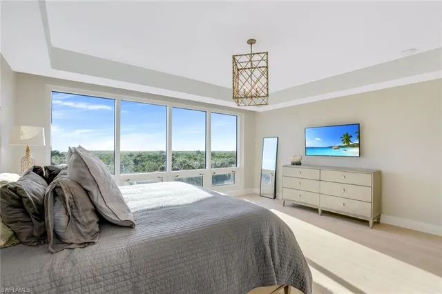 a bedroom with furniture and a flat screen tv