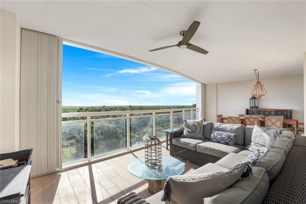 13915 Old Coast Road, Unit 502 Naples, FL 34110 - Photo 21 of 31 a living room with furniture and a large window