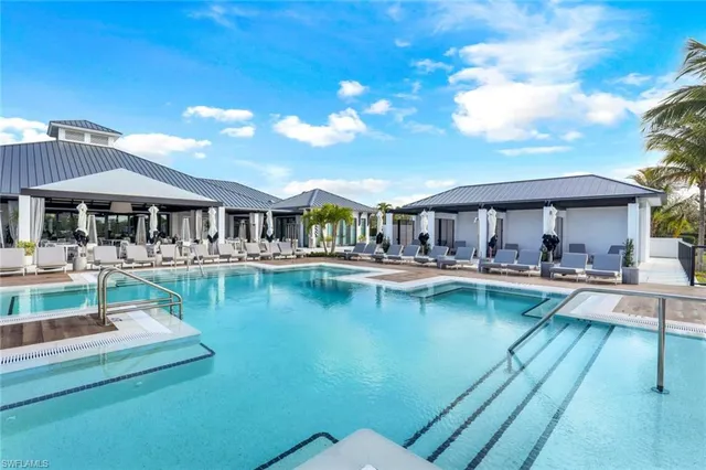 a view of a swimming pool with outdoor seating