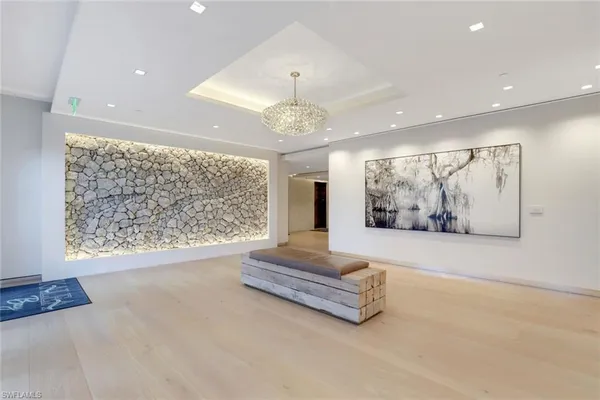 a living room with couch and a chandelier