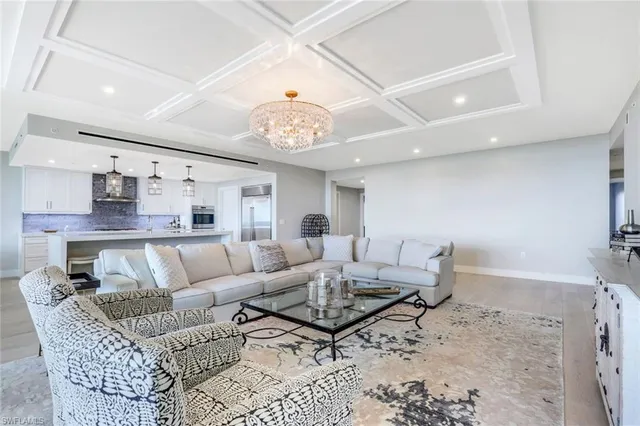 a living room with furniture and kitchen view