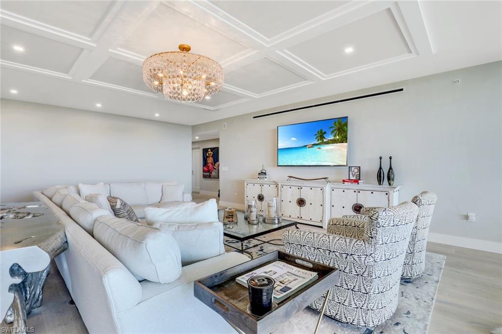 13915 Old Coast Road, Unit 502 Naples, FL 34110 - Photo 5 of 31 a living room with furniture and a flat screen tv