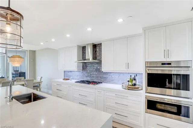 a kitchen with granite countertop a sink stainless steel appliances and cabinets