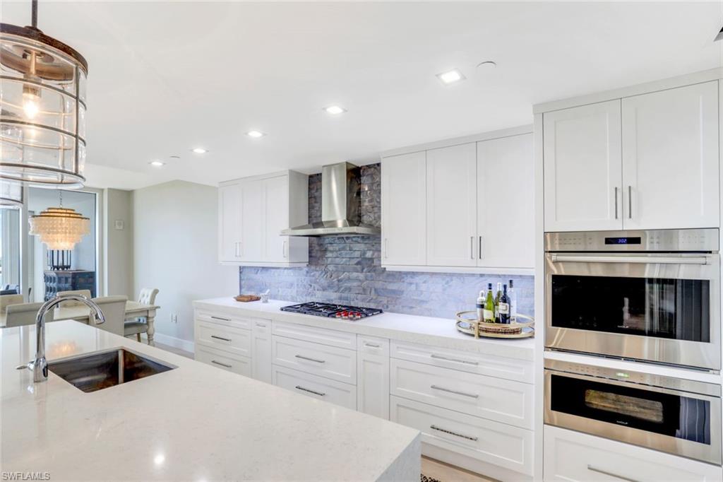 13915 Old Coast Road, Unit 502 Naples, FL 34110 - Photo 7 of 31 a kitchen with granite countertop a sink stainless steel appliances and cabinets