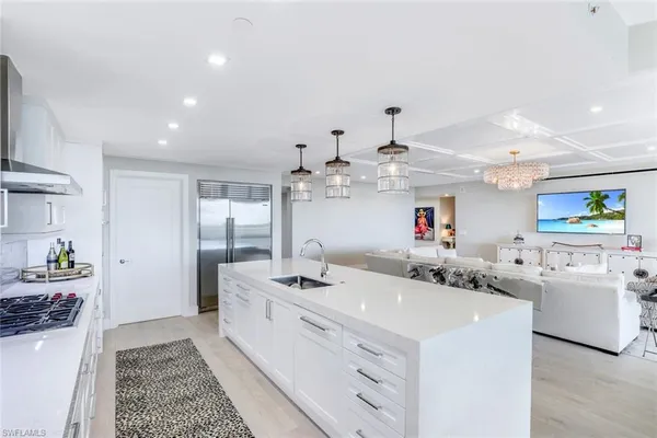 a kitchen with stainless steel appliances kitchen island granite countertop a sink and cabinets