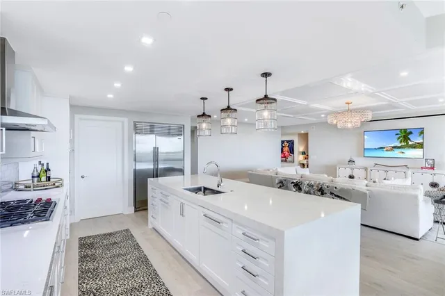 a kitchen with stainless steel appliances kitchen island granite countertop a sink and cabinets