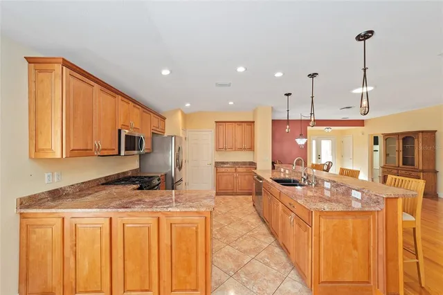 a kitchen with stainless steel appliances granite countertop a sink and cabinets