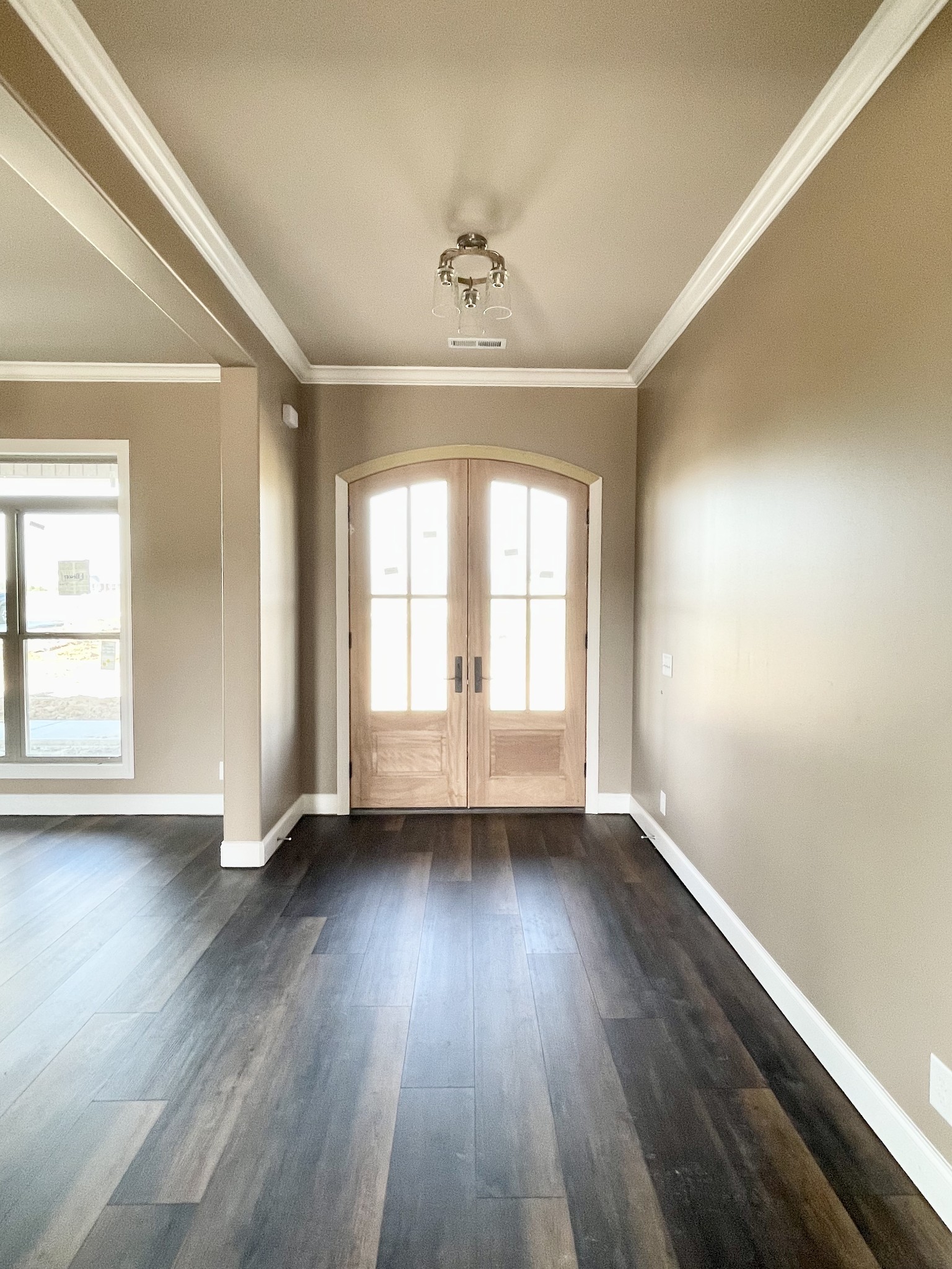 3262 Ostella Road Cornersville, TN 37047 - Photo 3 of 11 an empty room with wooden floor chandelier and windows