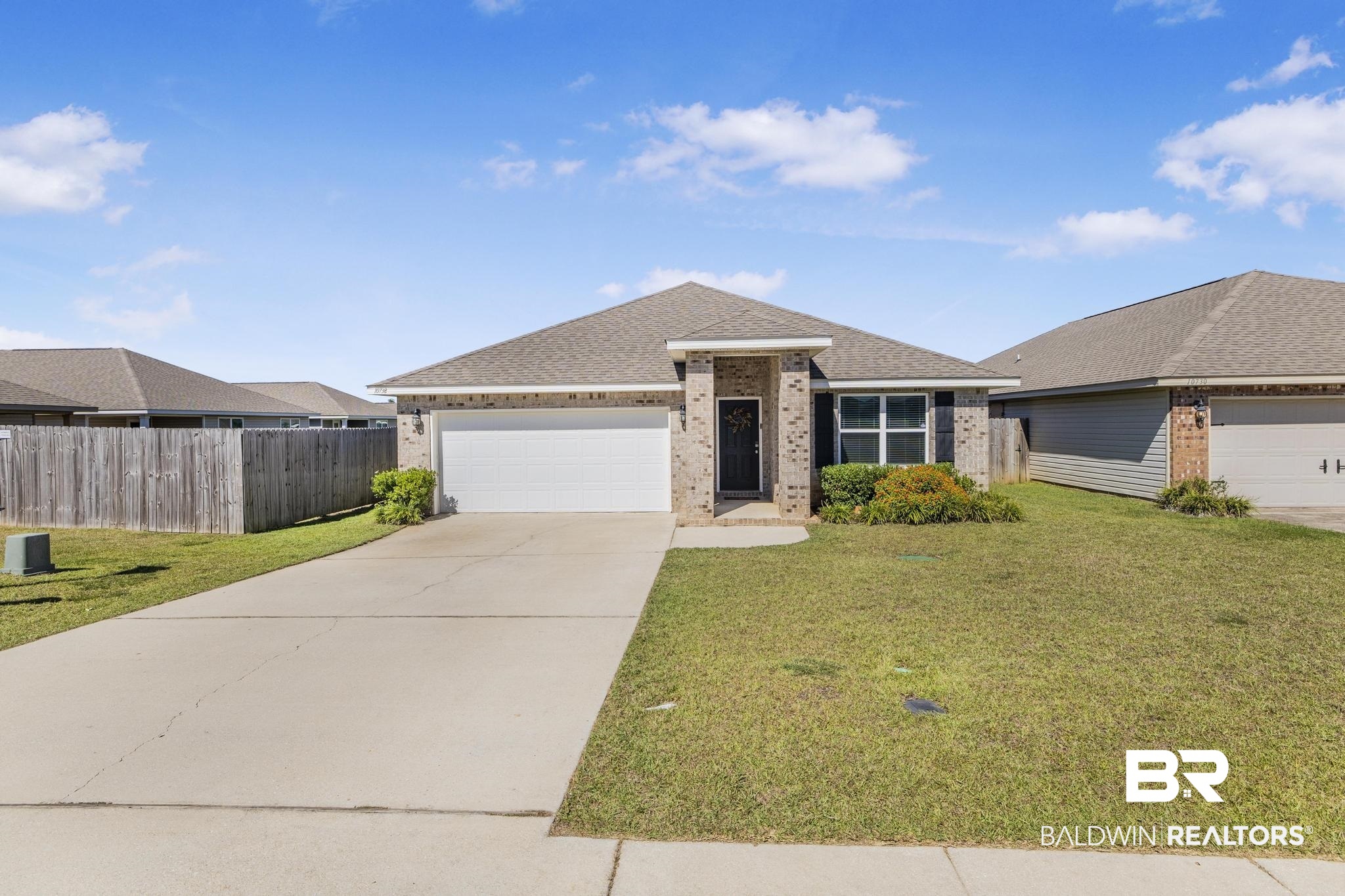 10738 Ridgeview Drive Mobile, AL 36608 - Photo 29 of 48 Ranch-style house with brick siding, a shingled roof, concrete driveway, and a garage