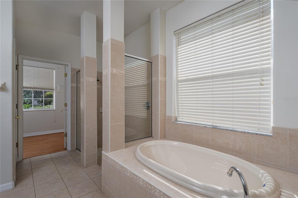 4420 85th Ave Circle East Parrish, FL 34219 - Photo 13 of 40 a bathroom with a bathtub and a shower