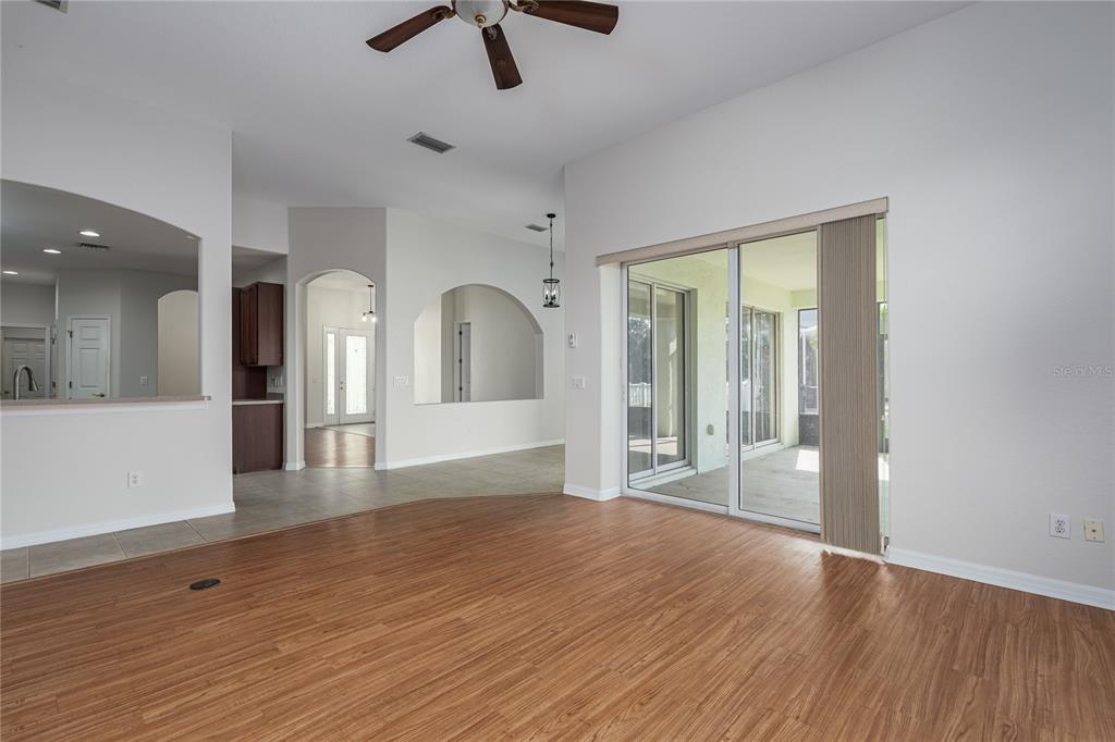 4420 85th Ave Circle East Parrish, FL 34219 - Photo 17 of 40 a view of empty room with wooden floor and fan
