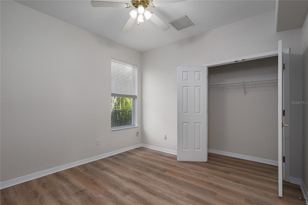 4420 85th Ave Circle East Parrish, FL 34219 - Photo 18 of 40 an empty room with wooden floor and windows