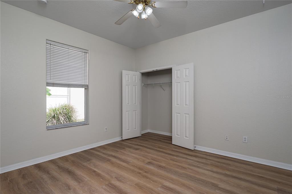 4420 85th Ave Circle East Parrish, FL 34219 - Photo 22 of 40 a view of an empty room with wooden floor and a window