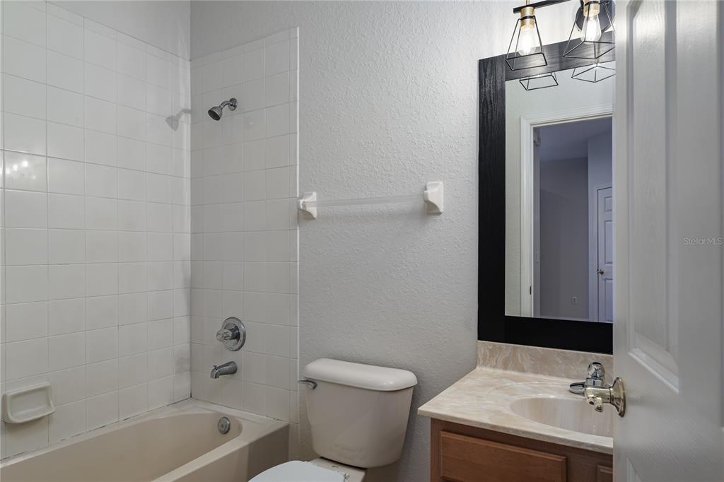 4420 85th Ave Circle East Parrish, FL 34219 - Photo 23 of 40 a bathroom with a sink toilet and shower