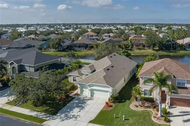 an aerial view of a house with a garden and lake view