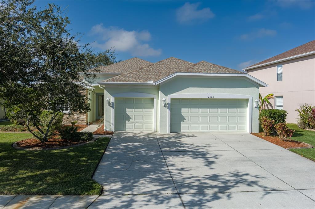4420 85th Ave Circle East Parrish, FL 34219 - Photo 3 of 40 a front view of a house with a yard and garage