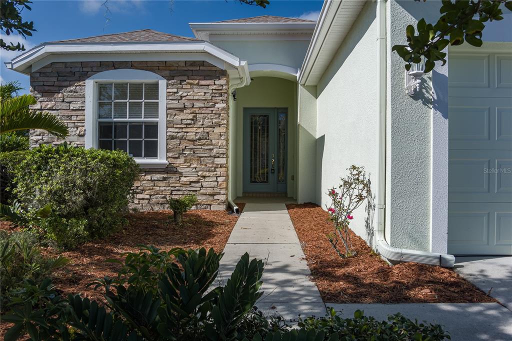 4420 85th Ave Circle East Parrish, FL 34219 - Photo 35 of 40 a front view of a house with garden