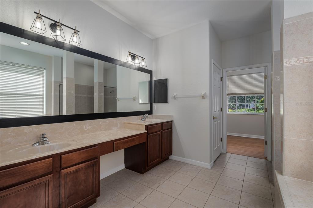 4420 85th Ave Circle East Parrish, FL 34219 - Photo 7 of 40 a bathroom with a sink and a large mirror