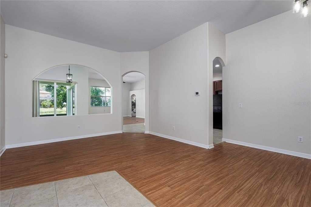 4420 85th Ave Circle East Parrish, FL 34219 - Photo 8 of 40 an empty room with wooden floor and windows
