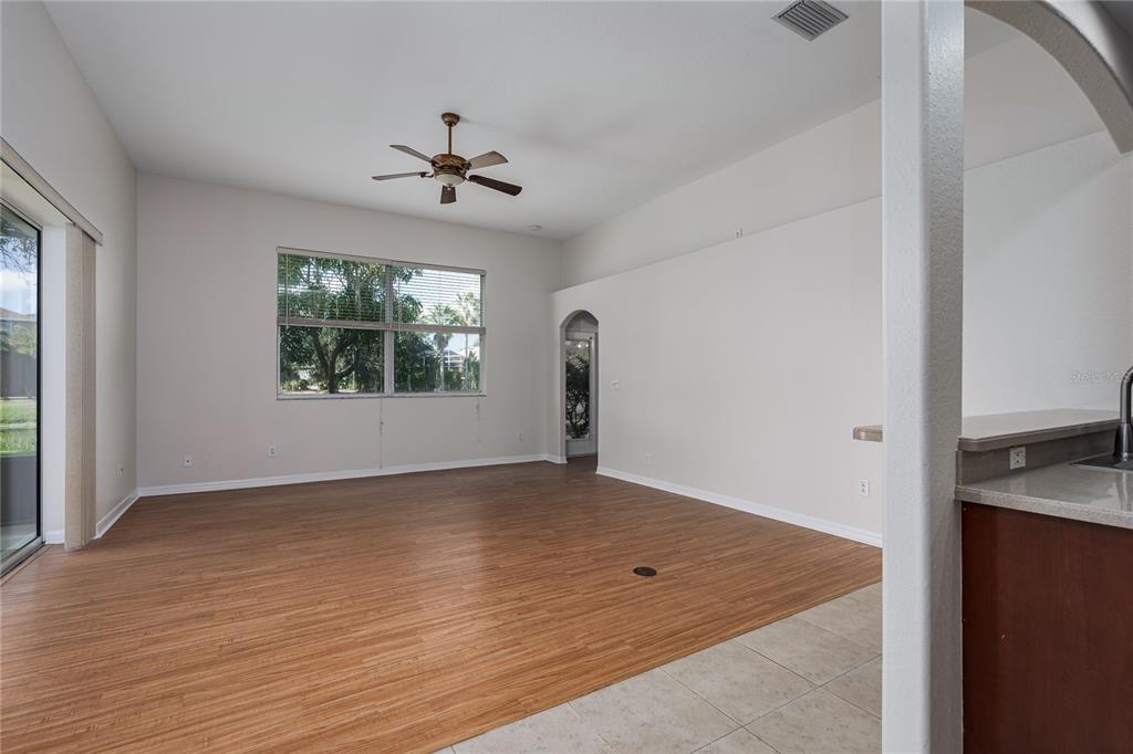 4420 85th Ave Circle East Parrish, FL 34219 - Photo 9 of 40 wooden floor in an empty room with a window