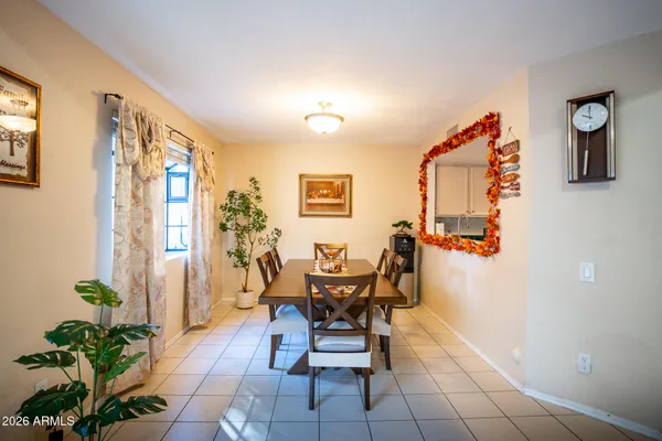 a dining room with furniture and window