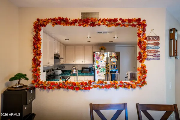 a view of a dining room with furniture one side kitchen view