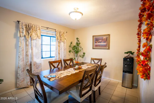 a dining room with furniture and window