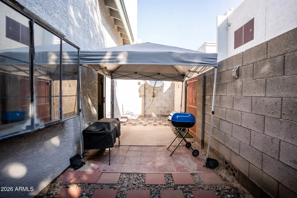 a view of a chairs and table in backyard