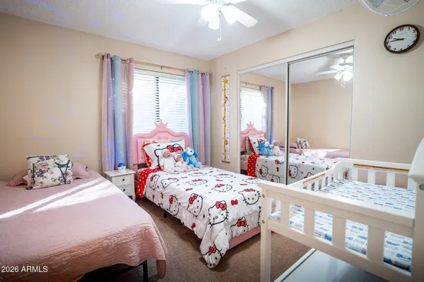 a bedroom with two beds and a large mirror